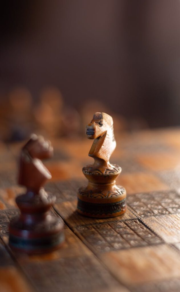 Intricate wooden chess pieces on a board, emphasizing craftsmanship.