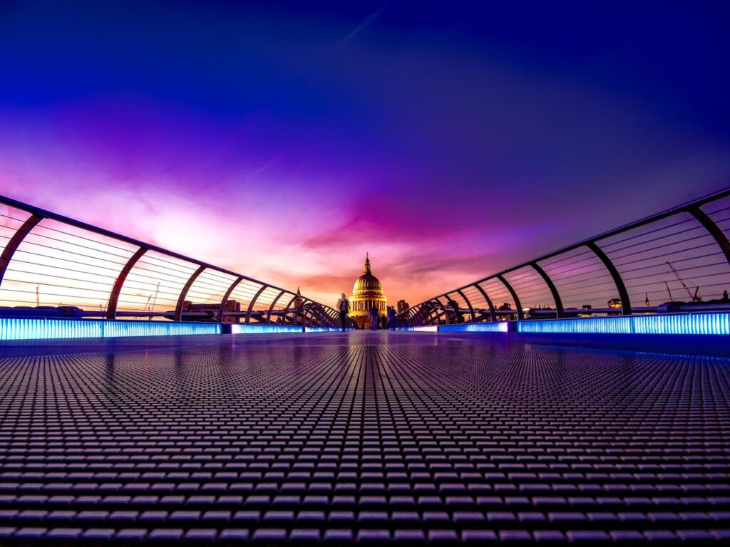 Captivating view of London's Millennium Bridge at sunset with St. Paul's Cathedral in the background.